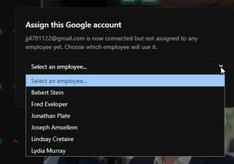 The assign dialog where a newly connected Google account is handed to a specific employee from a dropdown